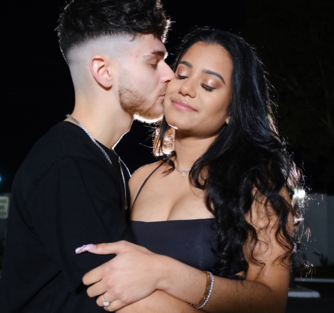 Man kissing his partner's cheek as they embrace at night