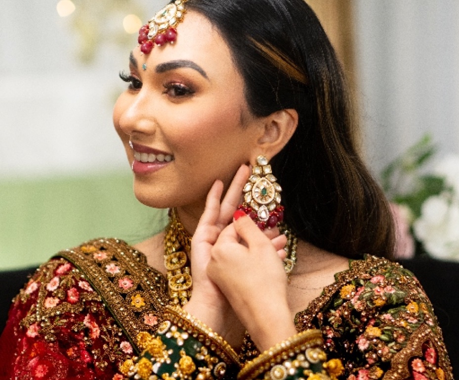 Smiling bride touching her earring